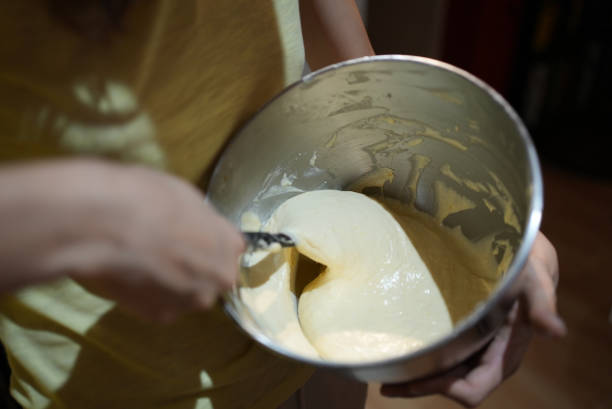 istock Stirring a bowl of raw dough for baking 1440703359