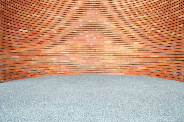 istock Red Brick Wall Background in Curved Style with Sand Pavement. 1440703460