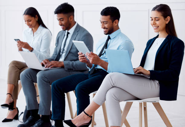 istock Job interview, recruitment and hiring with business people and technology for application, motivation and vacancy in corporate company. Waiting room, human resources and onboarding with employees 1440703669