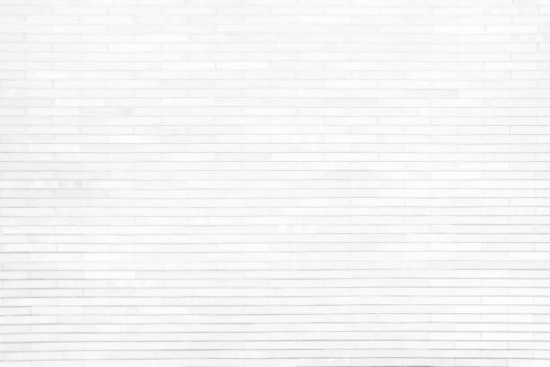 istock White Brick Wall Texture for Background with Light Beam from the Top. 1440703771