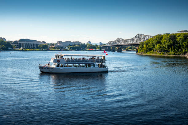 Ottawa, Canada - August 19, 2022: View to a tourboat on Ottawa River. Ottawa is the capital city of Canada.