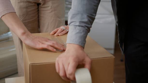 istock Couple packing up storage things in cardboard boxes 1440704205