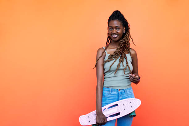 istock Young Black woman with penny board 1440704942