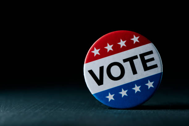 istock vote badge for the US election on a gray surface 1440706150
