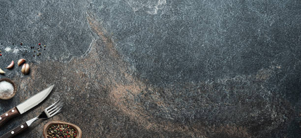 istock Table settings on empty graphite background. Top view of food background. 1440707671