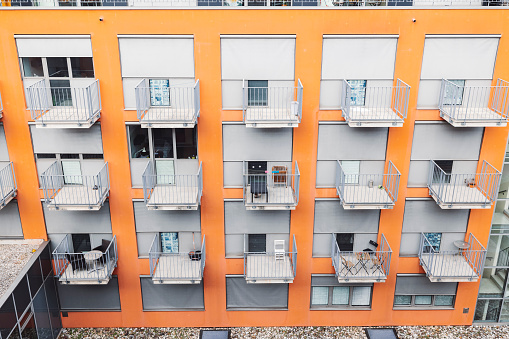 many small balconies with tables and chairs at a student residence in cologne
