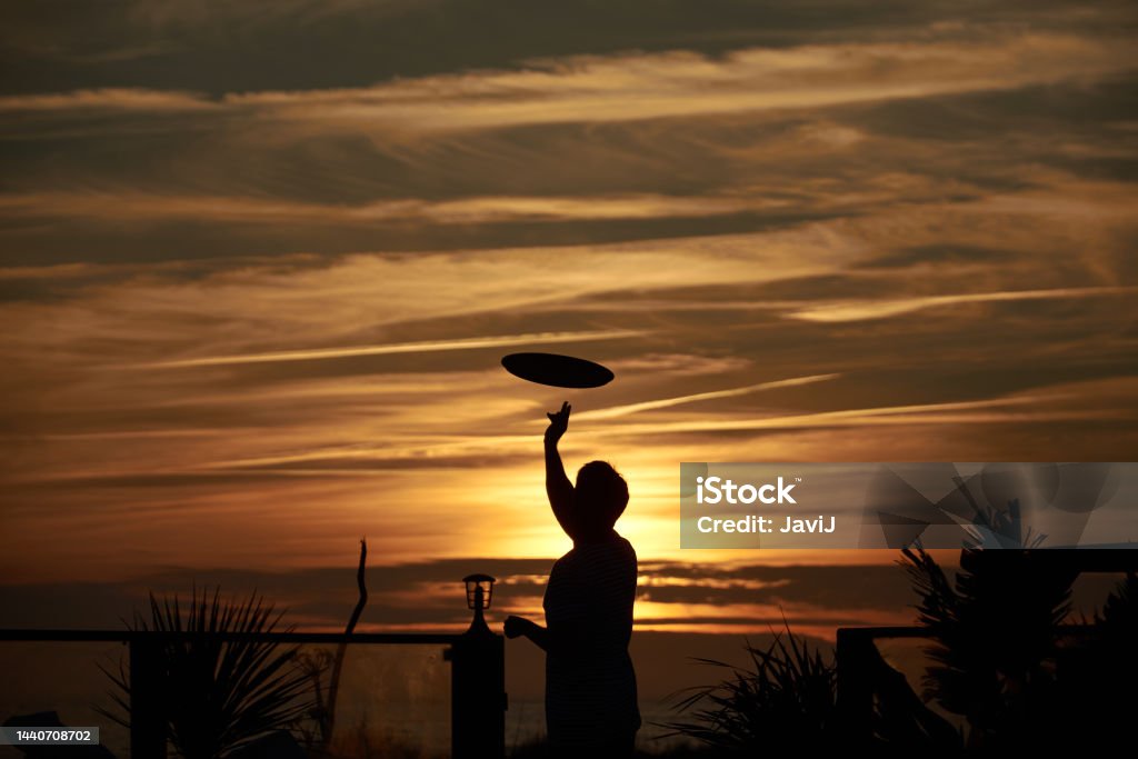 A waiter plays with his tray at Origen Club El Palmar, Vejer de la Frontera, Andalucia, Province of Cadiz, Spain Provincia de Cádiz, Andalucia, España Adult Stock Photo