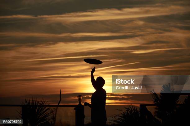 A Waiter Plays With His Tray At Origen Club El Palmar Vejer De La Frontera Andalucia Province Of Cadiz Spain Stock Photo - Download Image Now