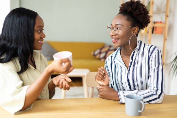 istock Two African American besties drinking morning coffee together 1440709802