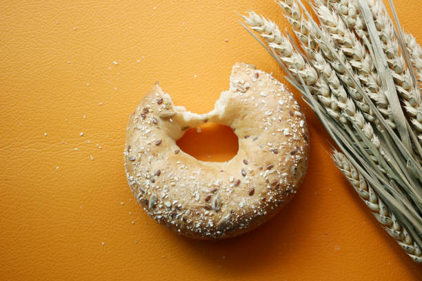 fresh bagel bread on orange background ,