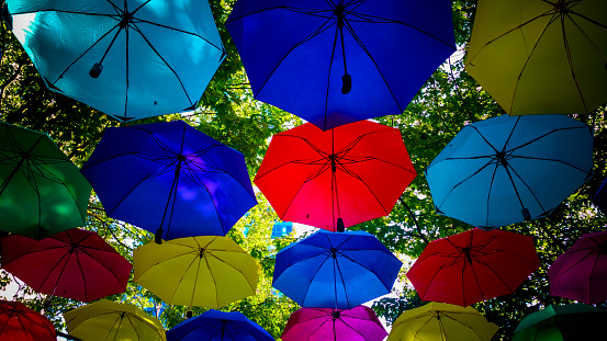 Multi-coloured umbrella's viewed from below