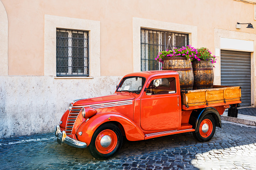Vintage red pickup on street in Trastevere. Rome, Italy.