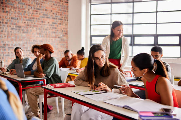 istock Students studying in a classroom with their teacher 1440718214