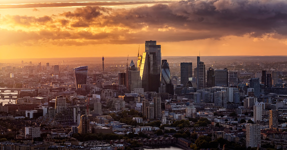 Elevated, panoramic view of the skyine at the City of London, England, during a golden sunset