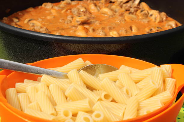 Whole grain pasta, peppers and mushrooms formed into a design.