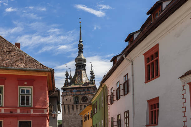 istock Clock Tower facade facing lower city hold clock dial, with black and gold hand-painted clock numbers, two niches with symbolic figurines on inside. Sighisoara, Romania 1440719602