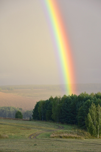 A bright rainbow over the Ural expanses after an autumn rain.