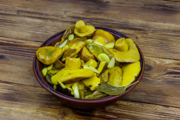 istock Tasty marinated mushrooms on wooden table 1440719986