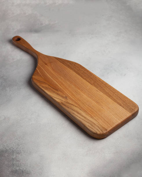 istock Wooden cutting board in the kitchen on a light background 1440722434
