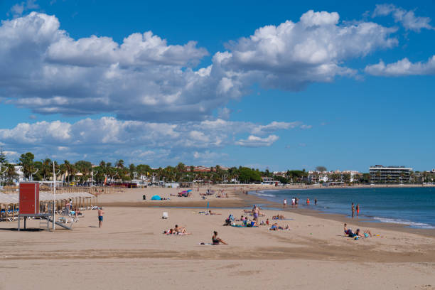 Cambrils beach Catalonia Spain Costa Dorada in beautiful September sunshine with visitors enjoying the warm weather on the Golden coast Beautiful weather for visitors to the beach at Cambrils Costa Dorada Catalonia Spain on Friday 30th September 2022 cambrils stock pictures, royalty-free photos & images