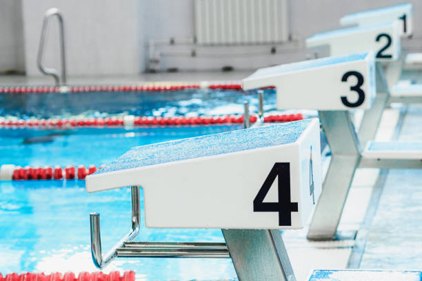 istock Starting table with numbers for diving in Olympic pool. Swimming pool for competitions with lane demarcation. Background. 1440722923