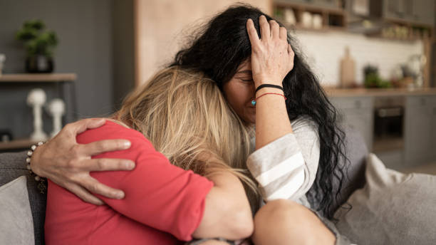istock Women supporting sad friend trying to solve a problem. 1440724235