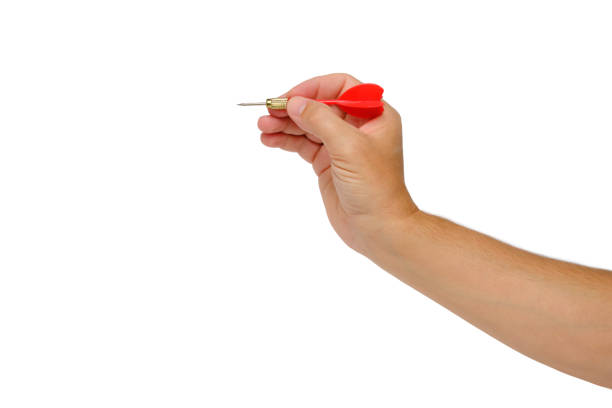 istock Hand holds dart for playing darts in red, on a white background of isolate.Concept striving for a goal in business and life. 1440724453