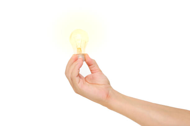 smiling attractive young man, holding the LED bulb in his hand