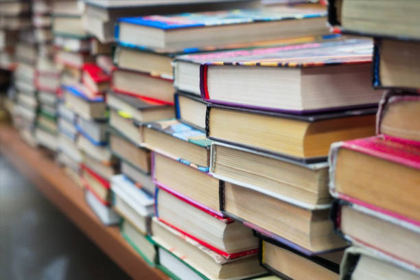 old used books are on table in bookstore. lot of books in stack at book flea market. background. - conference room sign imagens e fotografias de stock