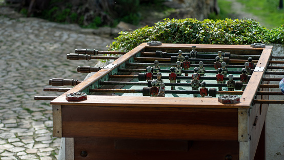 old foosball table over a cobble stone patio