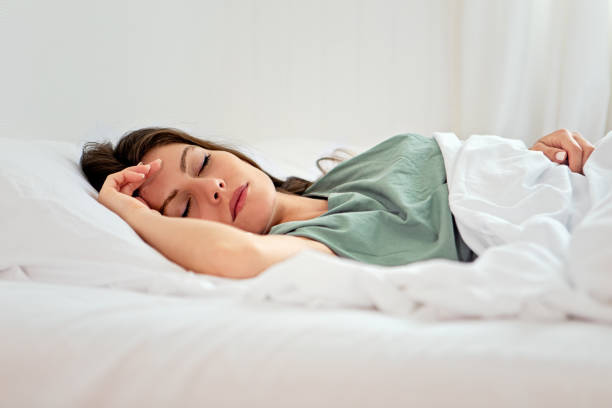 istock Young woman sleeping in her bed 1440725627
