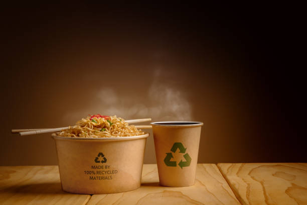 Recycled Packaging Concept. Recycled Bow with Hot Boiled Instant Noodles and Cup of Coffee on the Table. Zero Waste Materials. Environment Care, Reuse, Renewable for Sustainable Lifestyle stock photo