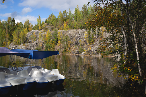 catamarans floating on the lake in the marble canyon surrounded by autumn forest.