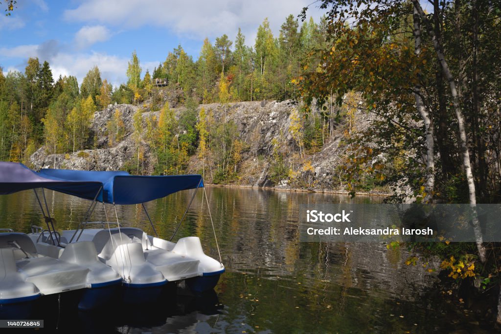 catamarans floating on the lake in the marble canyon surrounded by autumn forest catamarans floating on the lake in the marble canyon surrounded by autumn forest. Autumn Stock Photo