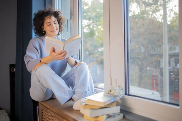 istock Woman relaxing and reading a book 1440727037