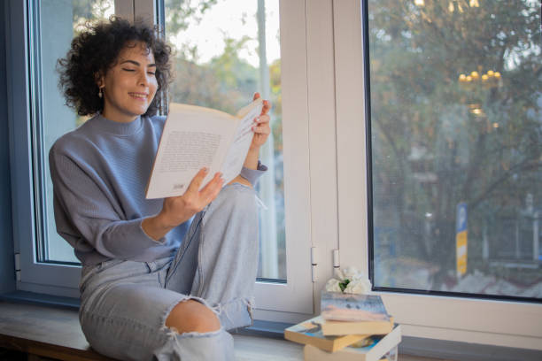 istock Woman relaxing and reading a book 1440727060