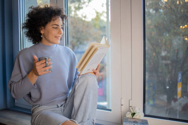 istock Woman relaxing and reading a book 1440727065