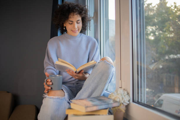 istock Woman relaxing and reading a book 1440727067