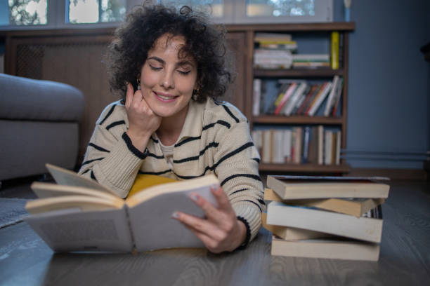 istock Woman relaxing and reading a book 1440727187