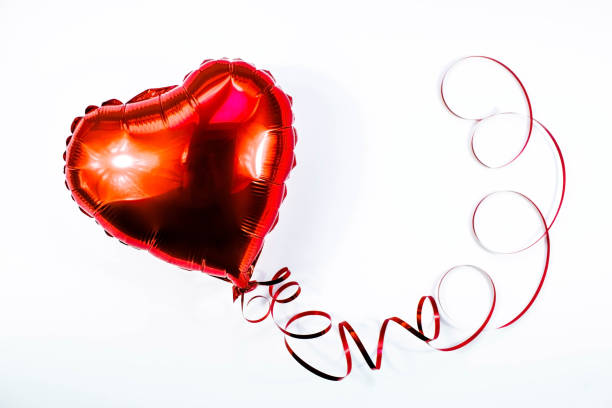 istock Banner. Red heart foil balloon on white Valentines Day background. Copyspace. 1440727928