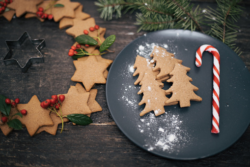 Christmas cookies shaped in cute stars, covered with flour and with decoration. Cookies are made with love.