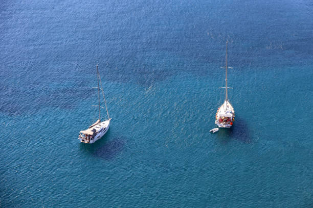 Two sailboats lying at anchor, background for traveling and vacation