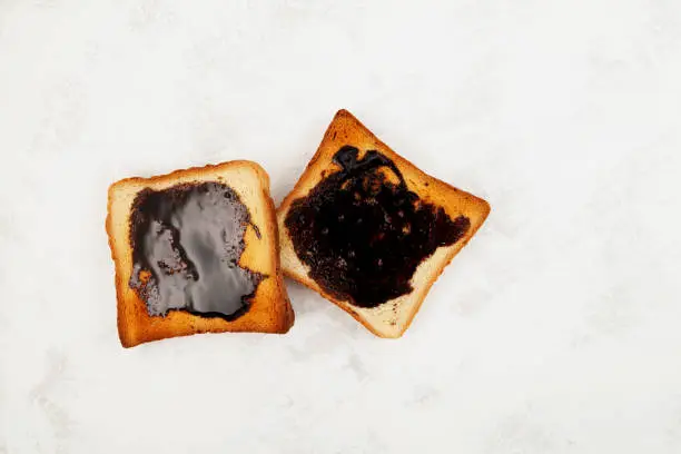 Photo of Two Roasted Aussie savoury toasts with vegemite spread, top view. Vegemite is a very popular yeast based spread in Australia