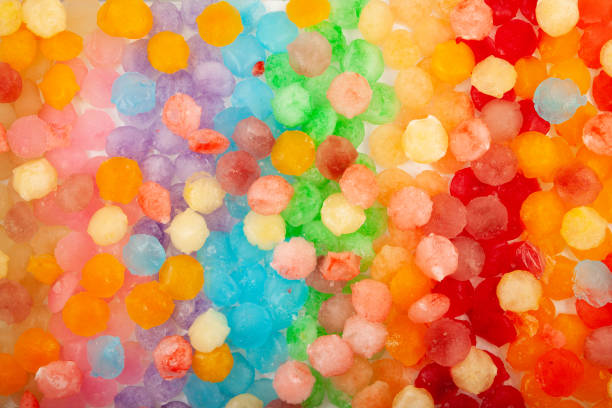 istock Colored ice cubes, close-up. Rainbow ice for cocktail or refreshing drinks and slush. Frozen fruit juice. Design element, selective focus 1440729818