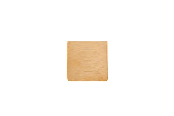 Square small serving wooden plate for small snacks from the chef. Empty plate for amuse-bouche or amuse-gueule isolated on white background. Design element.