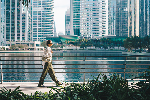 Businesswoman walking in Dubai. City lifestyle.