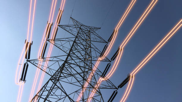 istock Electricity transmission towers with glowing wires 1440735985