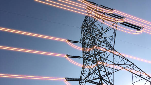 istock Electricity transmission towers with glowing wires 1440736004