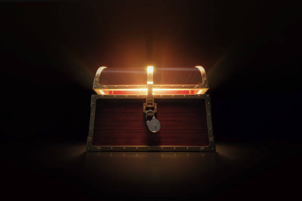 Glowing Wooden Treasure Chest On Black Background Glowing treasure chest on white background. Horizontal composition with copy space. Low angle view. antiquities stock pictures, royalty-free photos & images