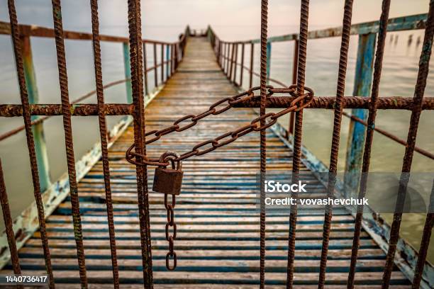 Rusted Chain Link And Padlock Close Metal Bars Of Old Pier Stock Photo - Download Image Now